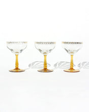 Load image into Gallery viewer, Set of three frosted glass champagne coupes with an amber handle. Shop the range of hand sourced glassware and ceramics by Rebecca Arts online.
