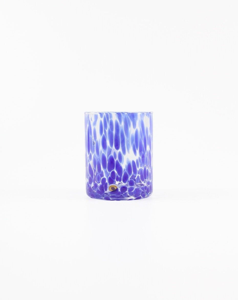 Murano tumbler in blue with a  speckled design. Shop the range of Murano tumblers hand sourced by Rebecca Arts online.
